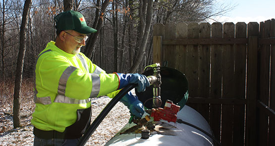 photo of EDP employee filling a propane tank